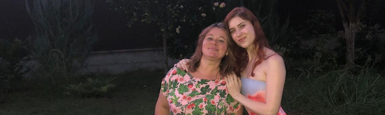 L'image montre une mère et sa fille ukrainiennes dans un jardin